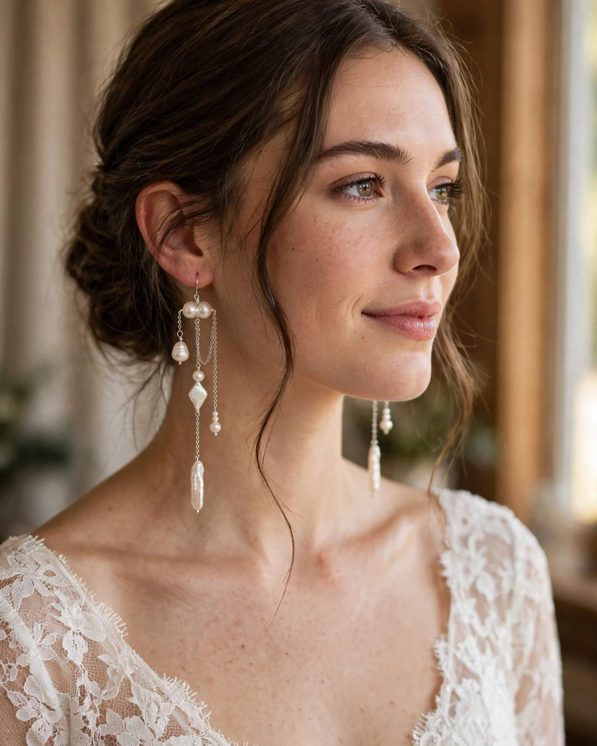 Bride wearing pearl dangle earrings with a sophisticated bridal look