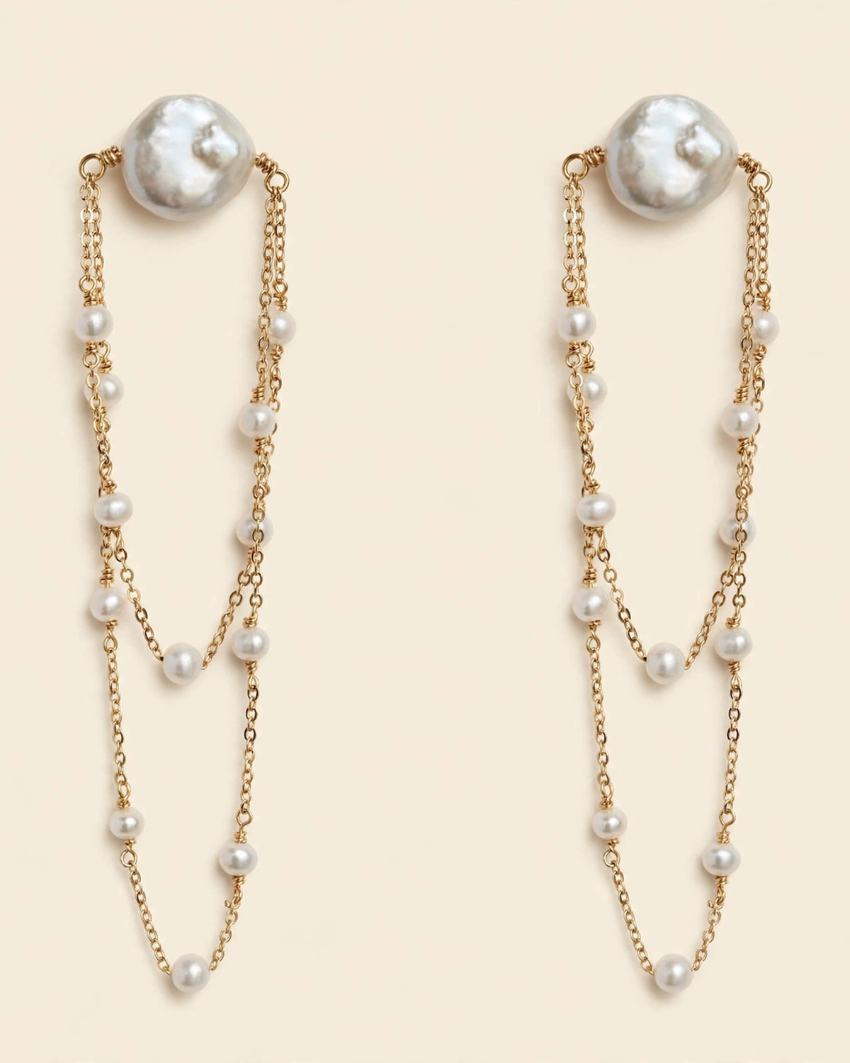 Freshwater pearl dangle earrings shown in a product view