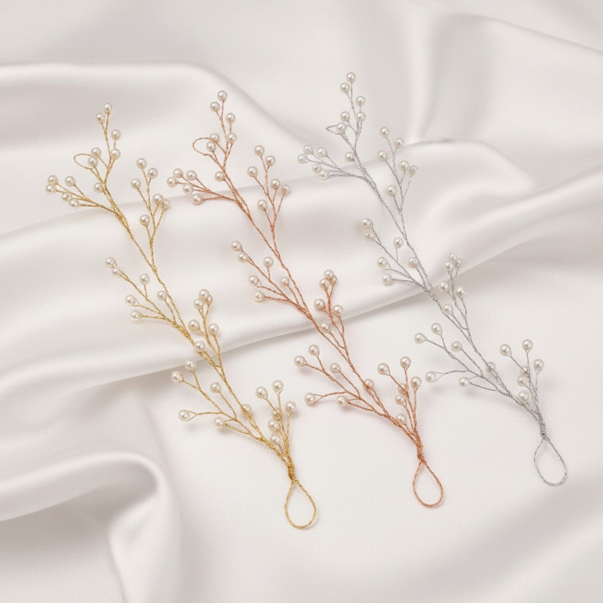 Simple bridal pearl vine placed on soft satin folds