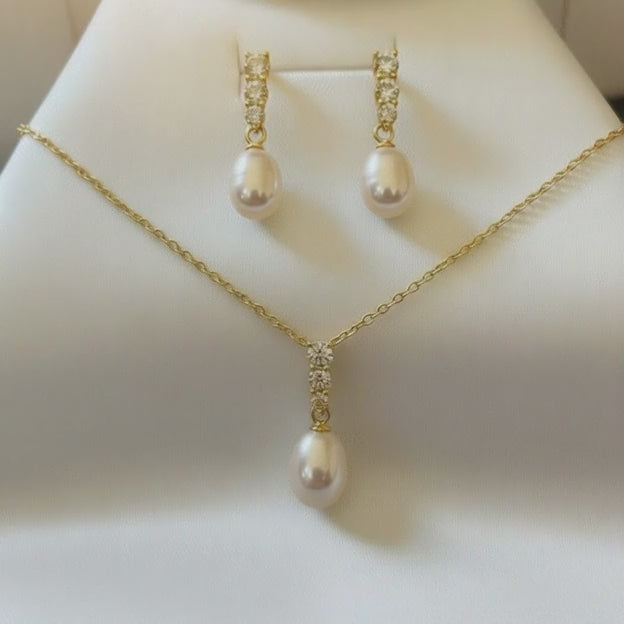 Close‑up of bride’s face highlighting teardrop pearl earrings with zirconia accents.