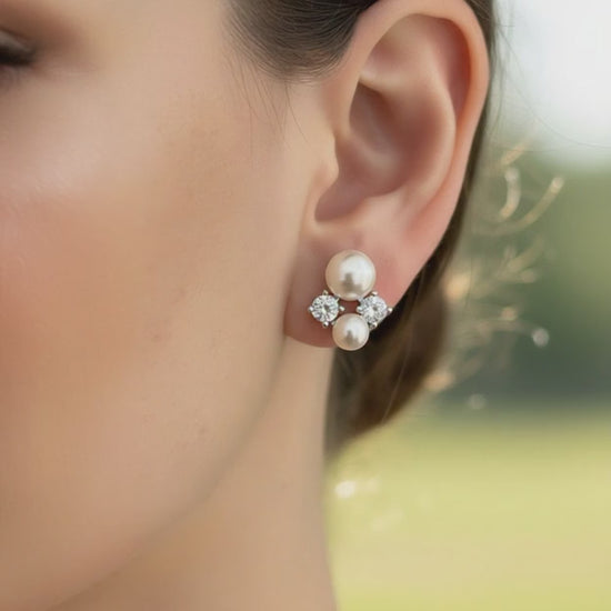 Elegant bridal look featuring freshwater pearl and zirconia earrings, photographed outdoors.