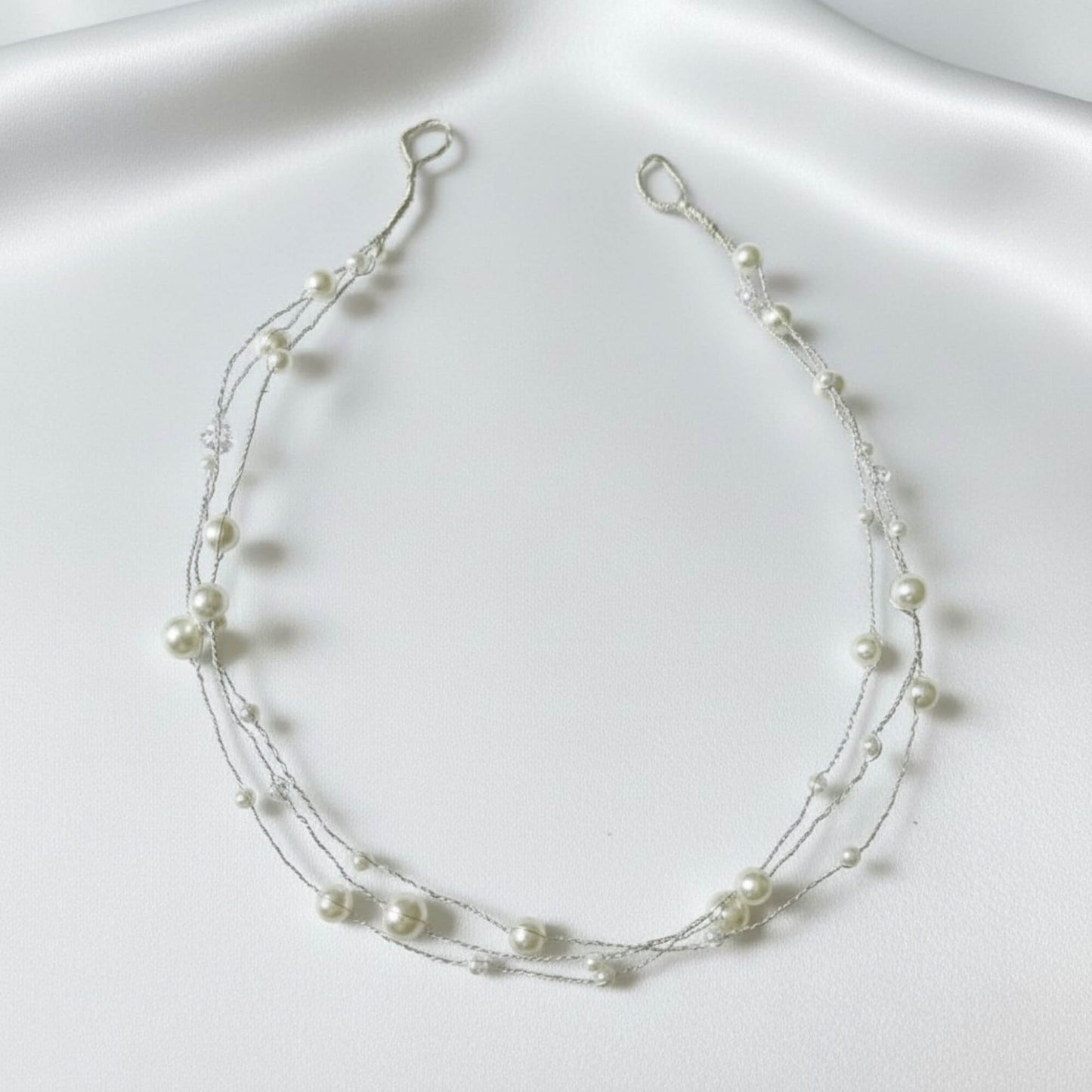 Silver Texture view of the minimal pearl hairvine on a soft satin background.