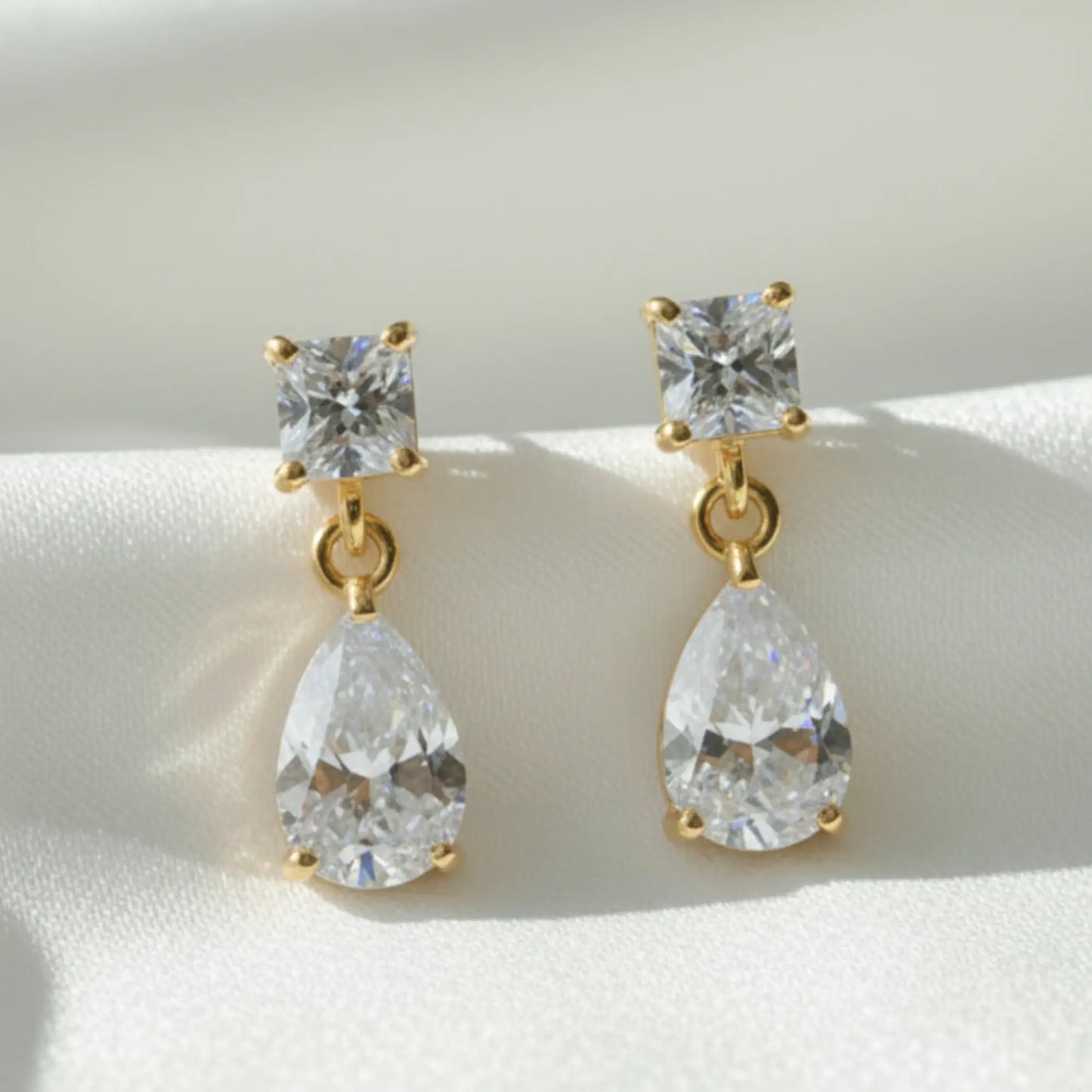 Square teardrSquare teardrop diamond drop earrings in 2cm length, gold or platinum plated, photographed for Australian bridal styling.

op diamond drop earrings in 2cm length, gold or platinum plated, photographed for Australian bridal styling.

