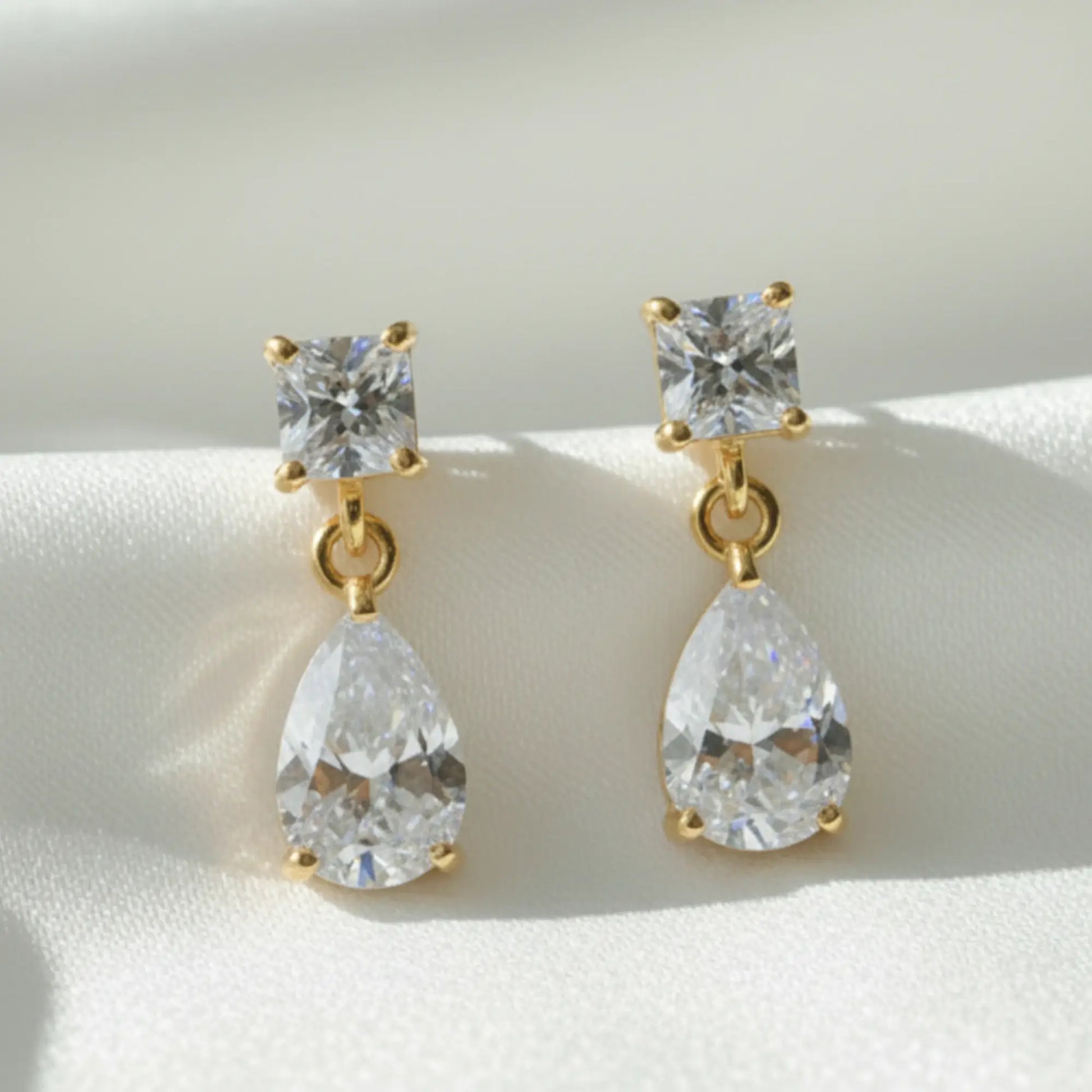 Square teardrSquare teardrop diamond drop earrings in 2cm length, gold or platinum plated, photographed for Australian bridal styling.

op diamond drop earrings in 2cm length, gold or platinum plated, photographed for Australian bridal styling.

